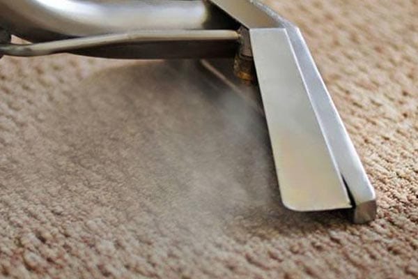 2–steam-carpet-one This image shows a steam cleaning machine being used to clean a carpet.