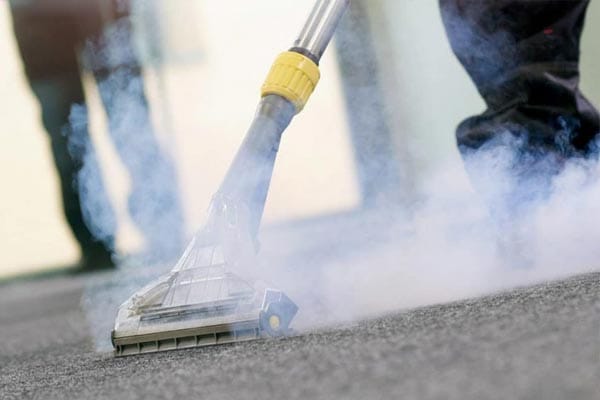3–steam-carpet-one This image shows a steam cleaning machine being used to clean a carpet.
