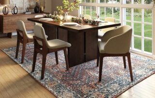 This image shows a dining area with a beautiful oriental rug.